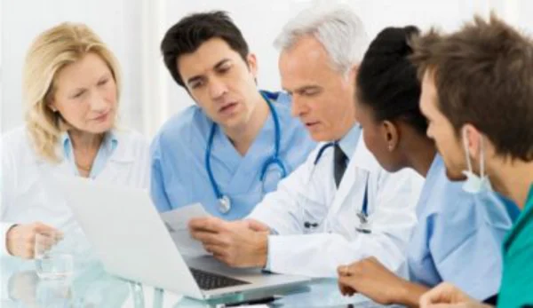 Health professionals having a discussion. UConn Online Nursing Graduate Degree Programs.