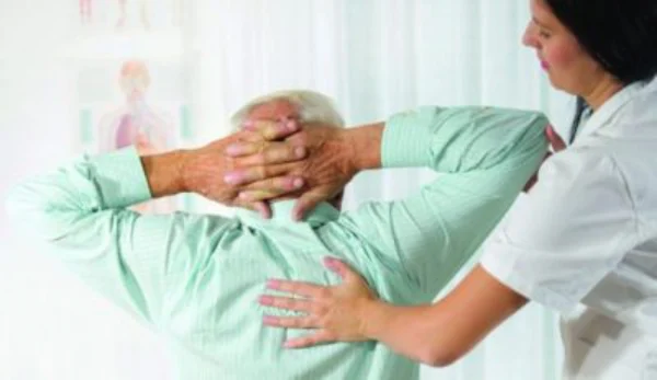 Nurse assisting patient with pain management exercises and therapy.