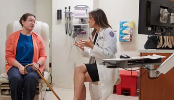 UConn Health Nurse having a discussion with patient. UConn Online Nursing Graduate Degree Programs.