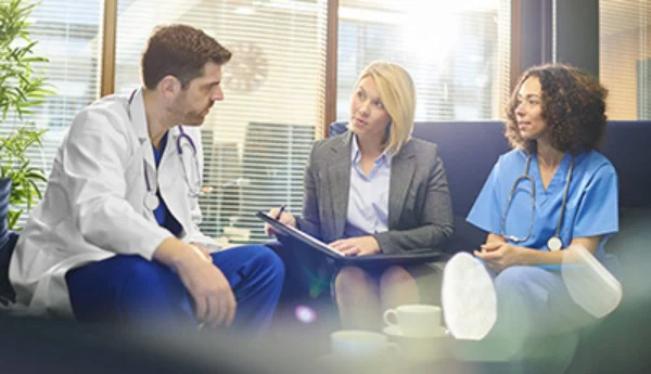 Nursing administrative staff sitting while having a discussion.