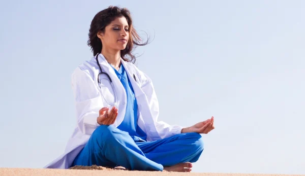 Nurse practicing holistic/yoga, UConn School of Nursing Online Graduate Degree Programs